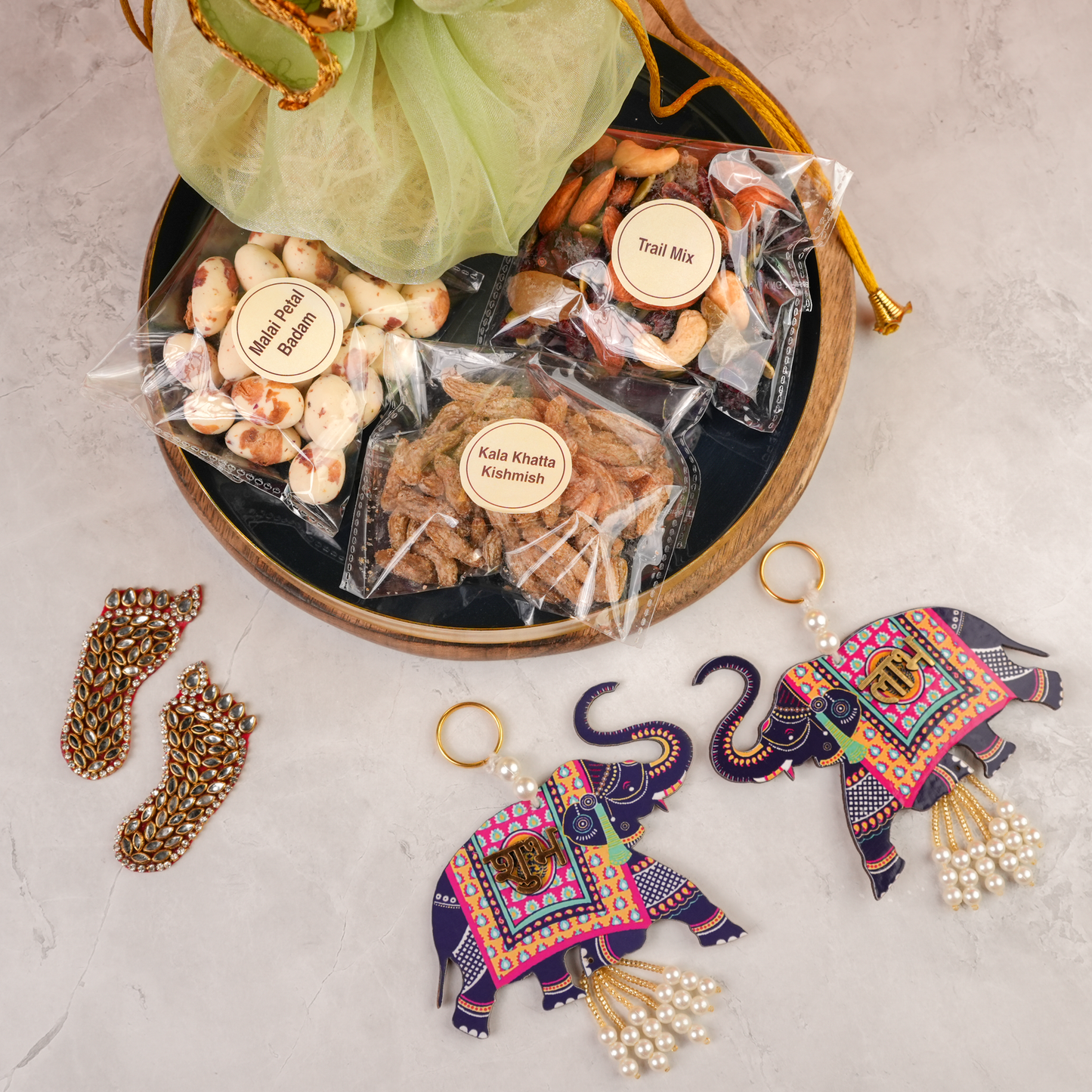 Festive Potli Gift Pack open display – green organza potli opened to reveal assorted festive dry fruits, diwali accents and treats.