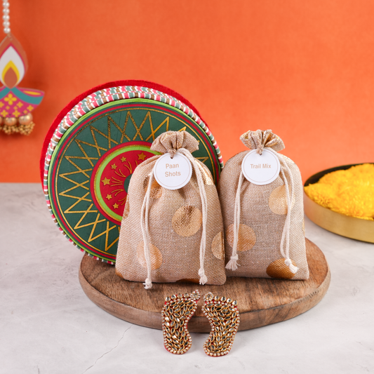 Chakri Diwali Gift Pack open round box with festive chakri design, two jute potlis, and decorative Laxmi Charan for Diwali gifting.