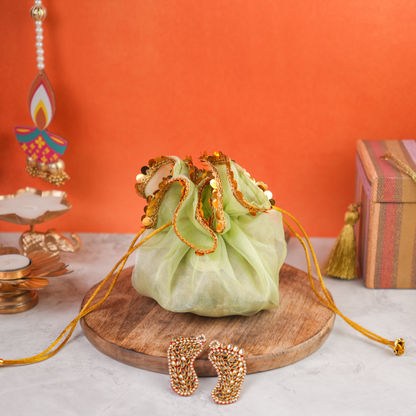 Festive Potli Gift Pack close-up front view highlighting the rich golden sequin design and festive organza potli detailing.