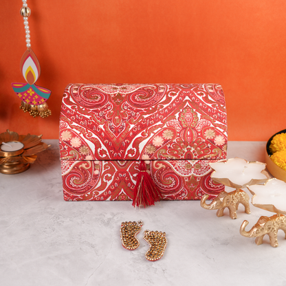 Closed Paisley Celebration Sandook Box with red paisley fabric, golden tassel closure, and festive detailing styled for Diwali gifting.