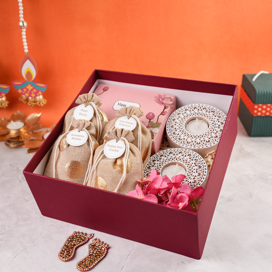 Full contents of Ruby Royale festive hamper including jute potlis, tealight holders, and décor accents.